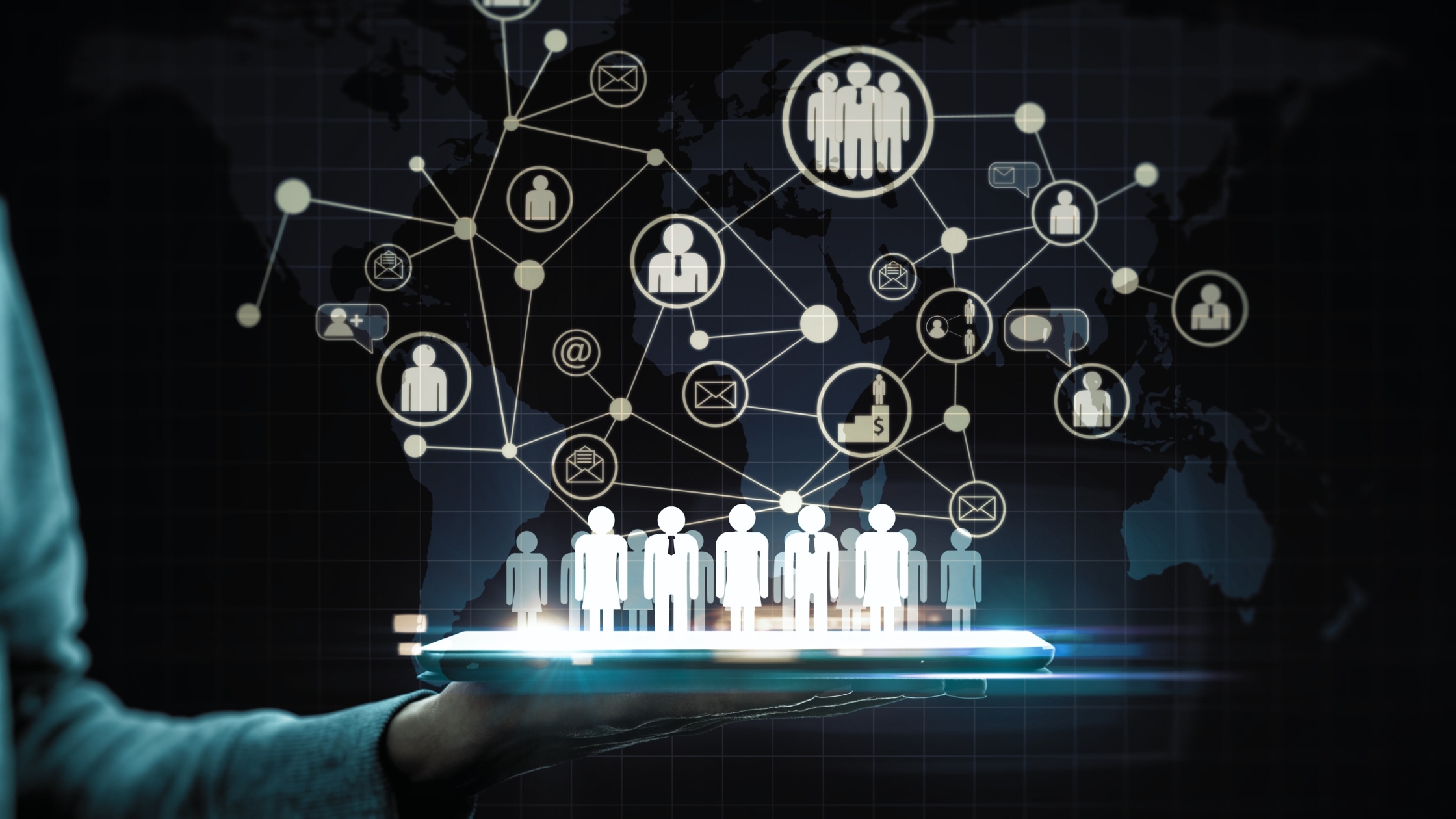Hand holding a laptop with hologram people connected